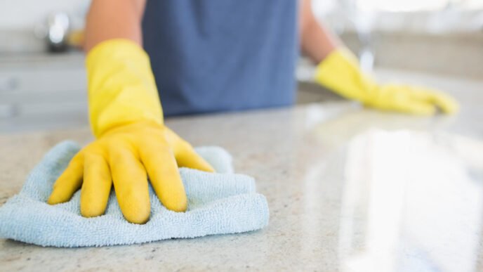 Woman,Cleaning,The,Counter,In,The,Kitchen