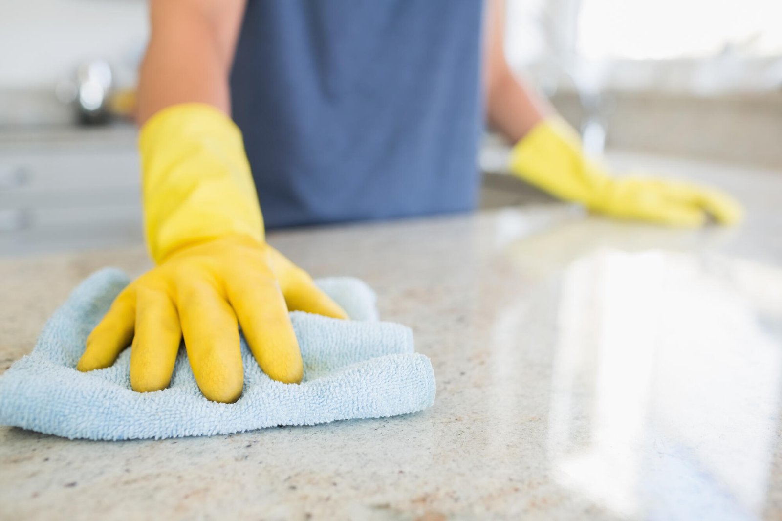 Woman,Cleaning,The,Counter,In,The,Kitchen